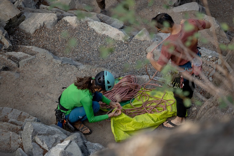 Two climbers get their rope ready to climb.