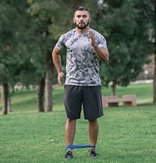 Goal_BCS_Band_Walk_A Starting a resistance band walk exercise in a park
