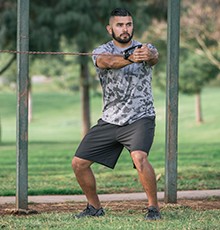 Goal_BCS_Core_Rot_B Finishing a core rotation with resistance band exercise in a park