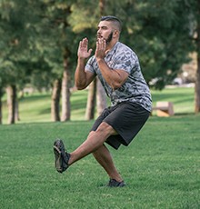 Goal_BCS_Single_Leg_Heel_B Finishing a side hop to single leg squat exercise in a park