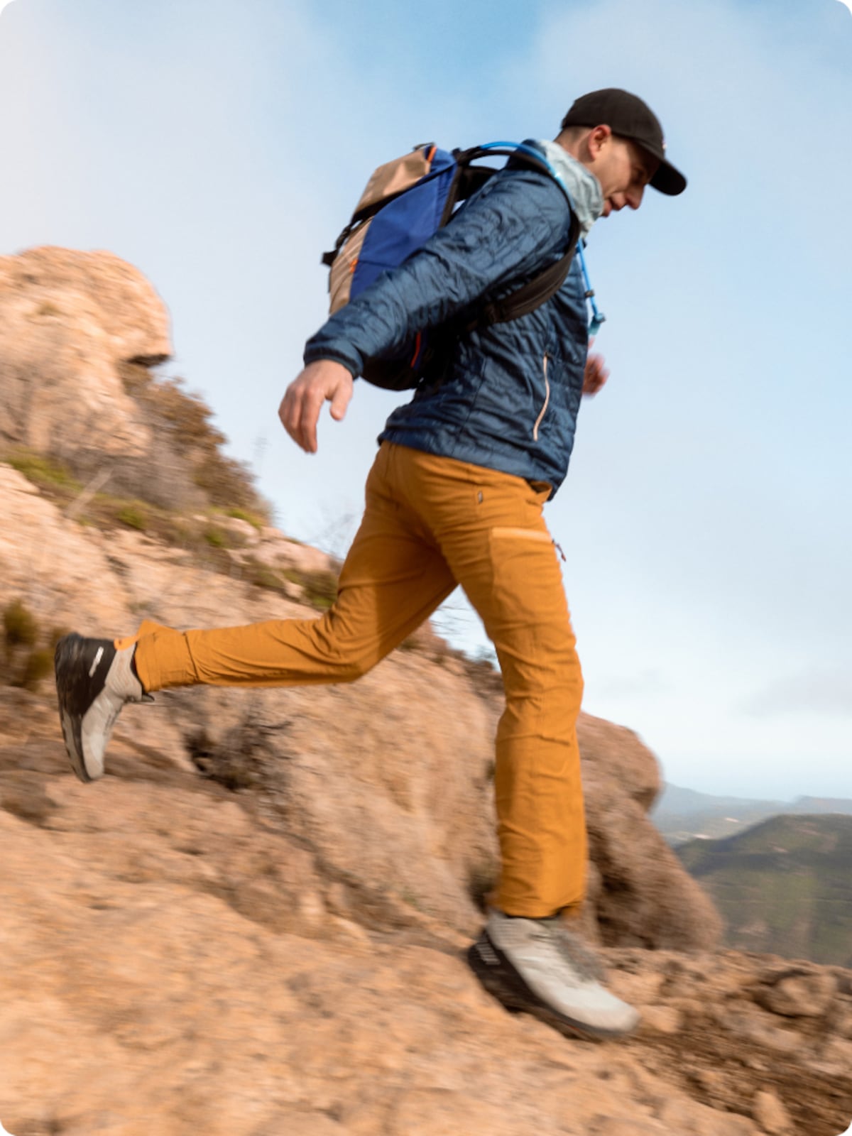 A hiker descending a rocky trail.