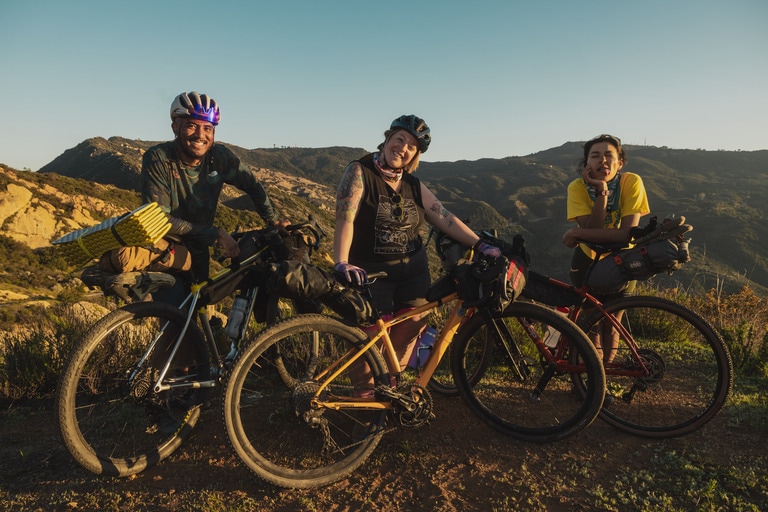 Three bikepackers in the mountains