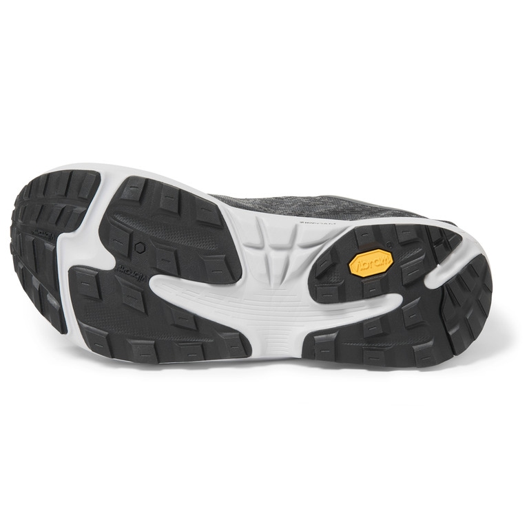A zero-drop trail-running shoe shown laying on its side with its outsole exposed