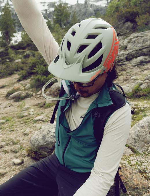 A cyclist hydrating during a break from riding.