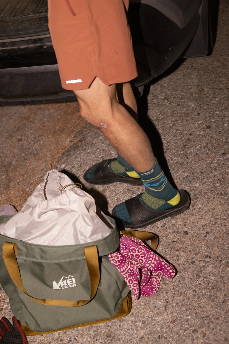 A runner wears Oofos recovery sandals