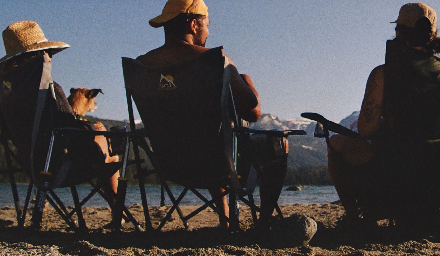A photo by REI Co-op Member Dj B-H. of friends (and dog!) soaking up the sun at a lakeside beach.