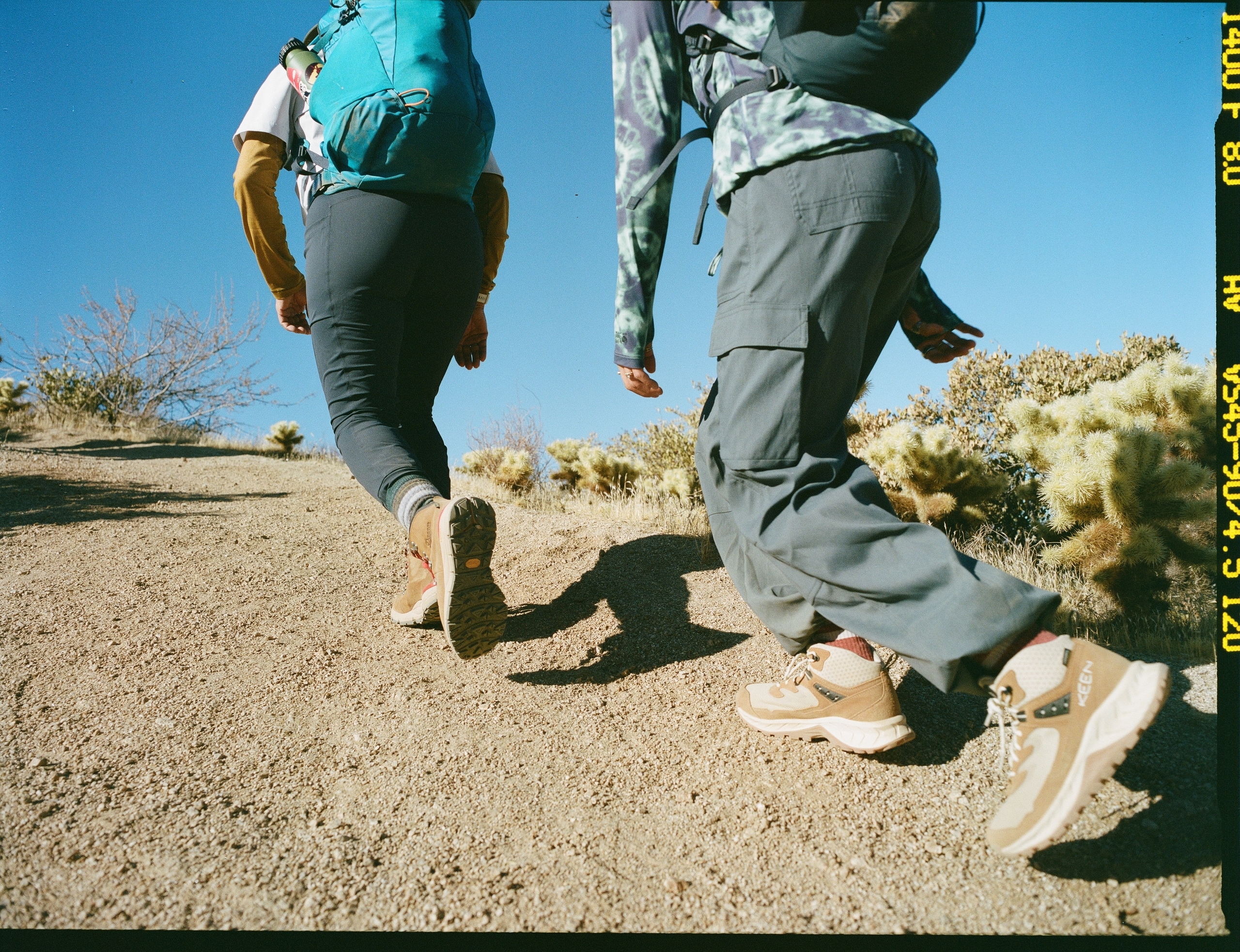 Two hikers head uphill wearing KEEN Hightrail Mid Waterproof HIking Boots