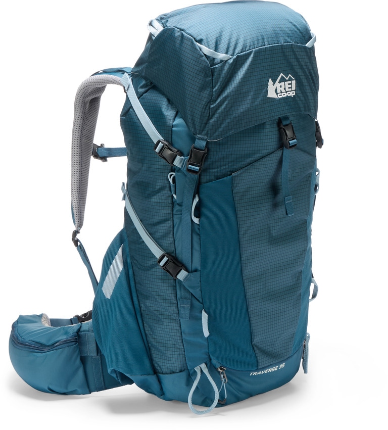 A blue 35-liter daypack standing up against a white background