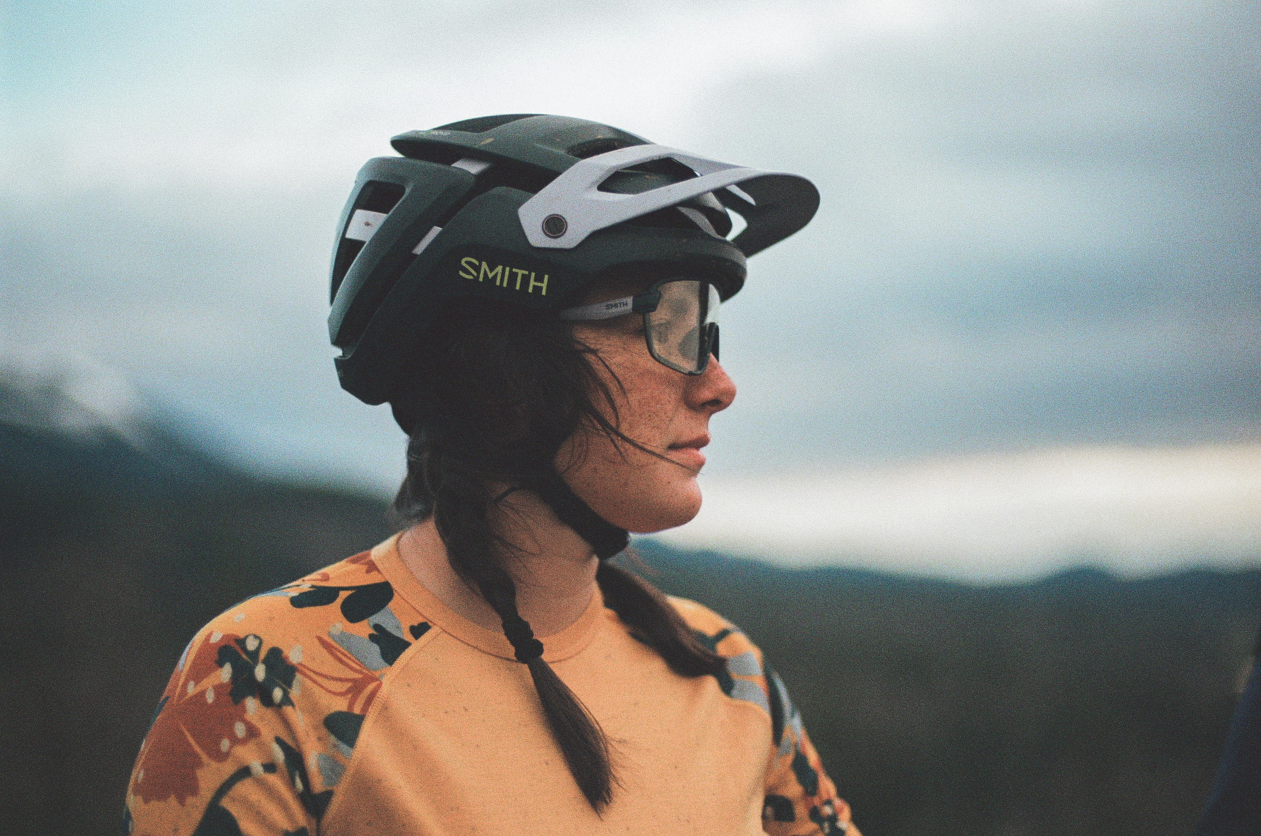 A person with a mountain bike helmet