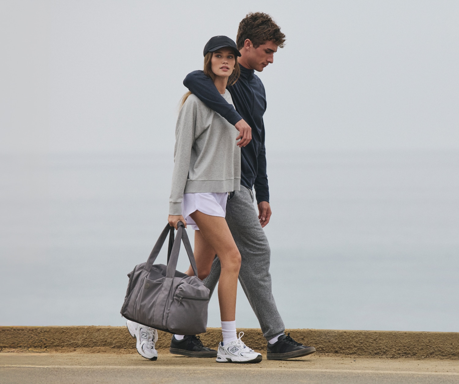 Two people walk together in their Vuori clothing