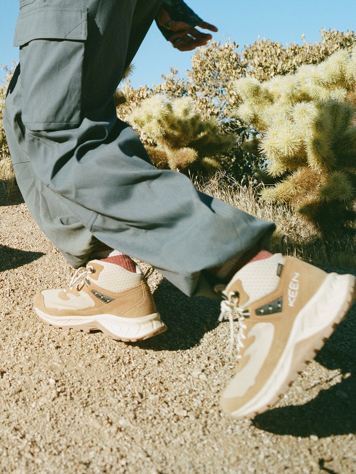 A person hikes up a trail in their Keen boots.