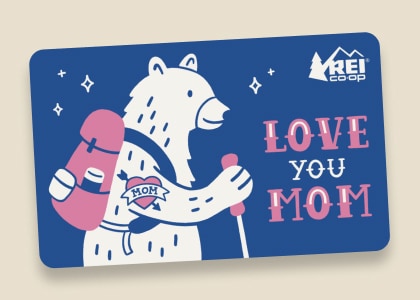 An R E I Co-op gift card that reads 'Love you mom' with an image of a bear going hiking.
