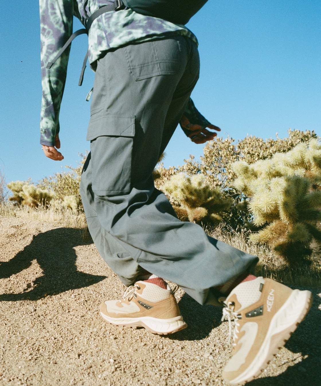 A person hikes up a trail in their Keen boots.