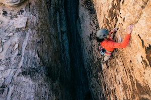 A climber scaling a rock face