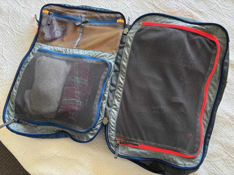 The Cotopaxi Allpa travel pack opened to reveal two inside compartments.