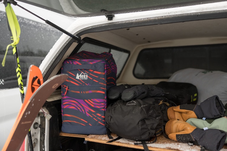 A boot bag keeps gear organized in the trunk space of a car.