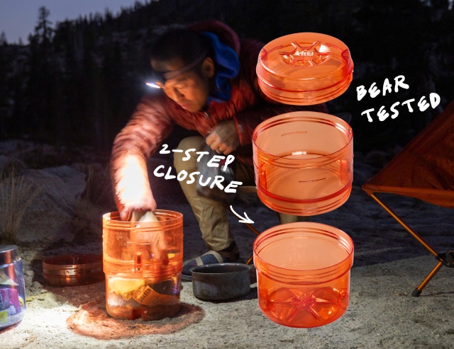 Camper at night sitting while working with a bear canister. Headline: 2-STEP CLOSURE. BEAR TESTED