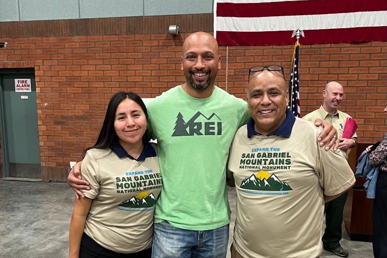 Three people pose at the Mobilizing for Monuments event.