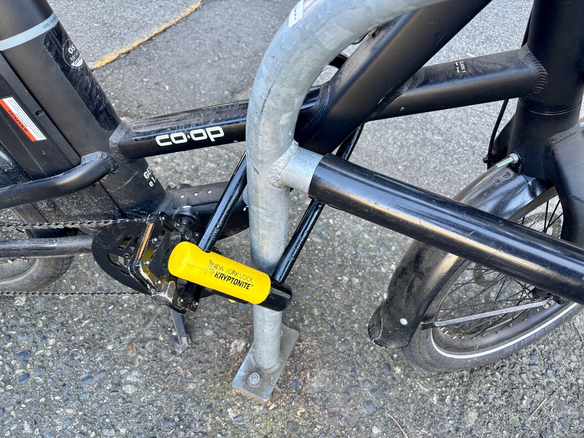 A bike locks secures an electric bike to a bike rack.
