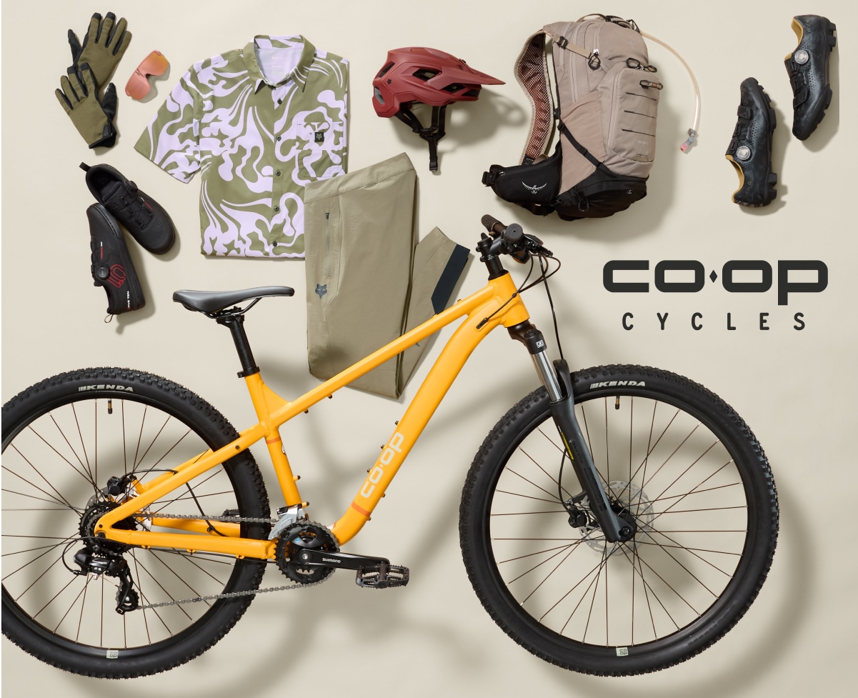 A Co-op Cycles bike with a collage of clothing and gear.