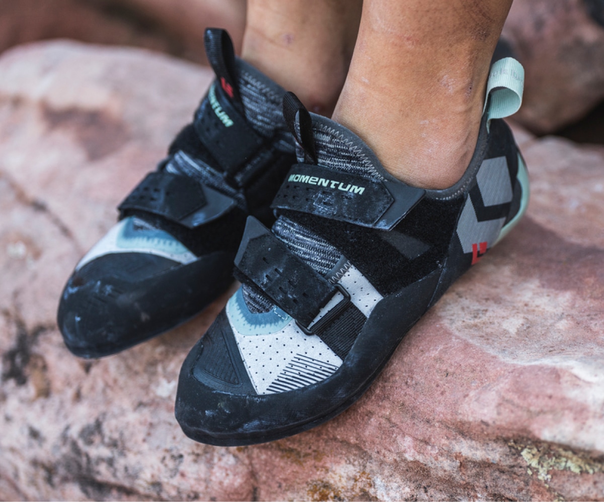 A person wearing the new Black Diamond Momentum climbing shoes.