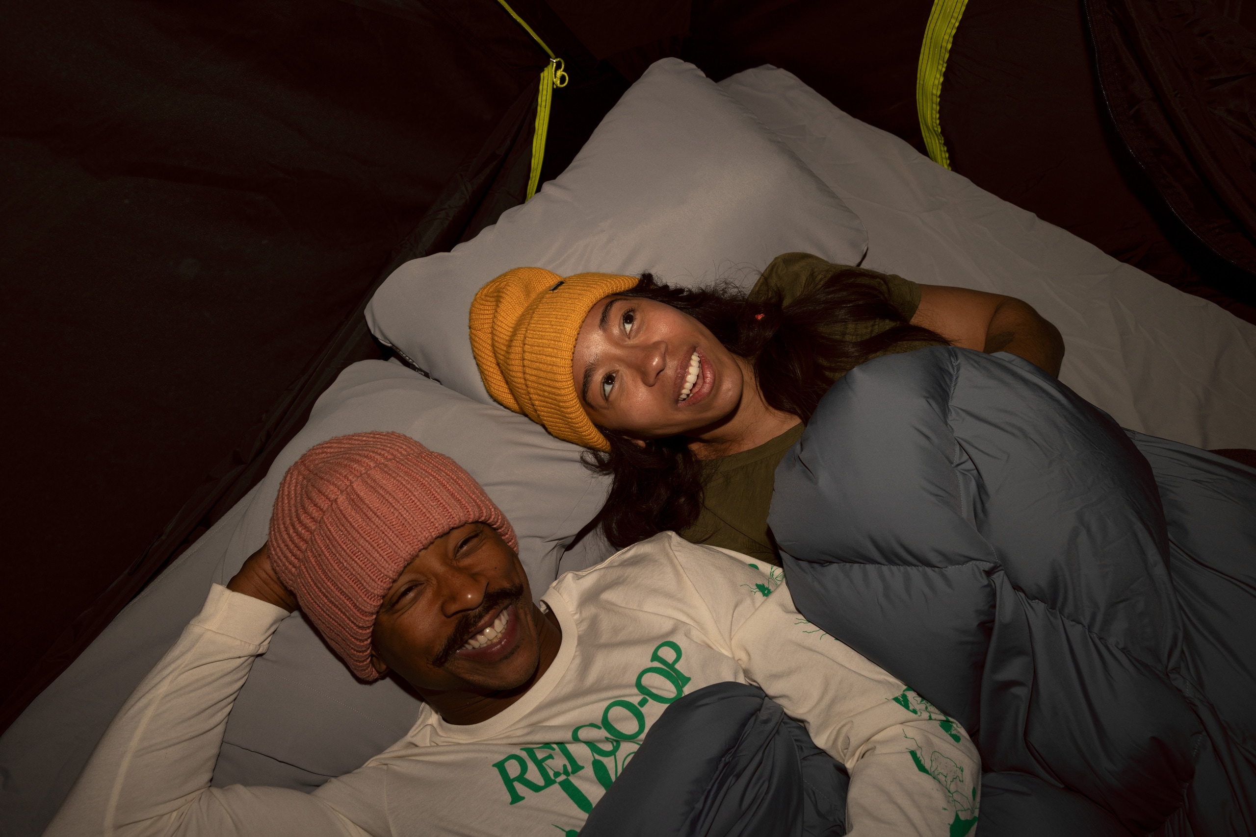 Two campers sleep inside a tent using Hest Camp Pillows