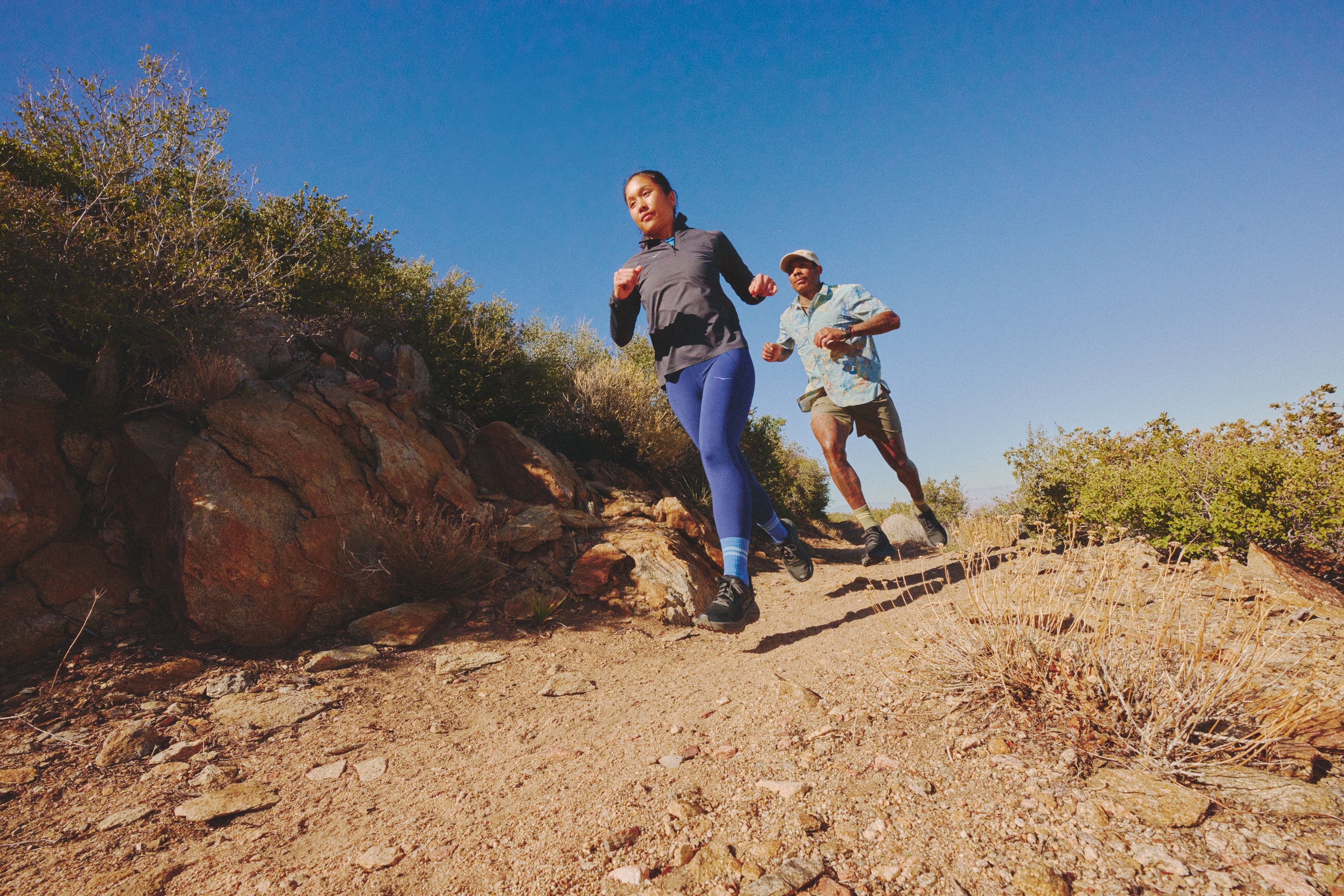 People trail running wearing HOKA Challenger 8 running shoes