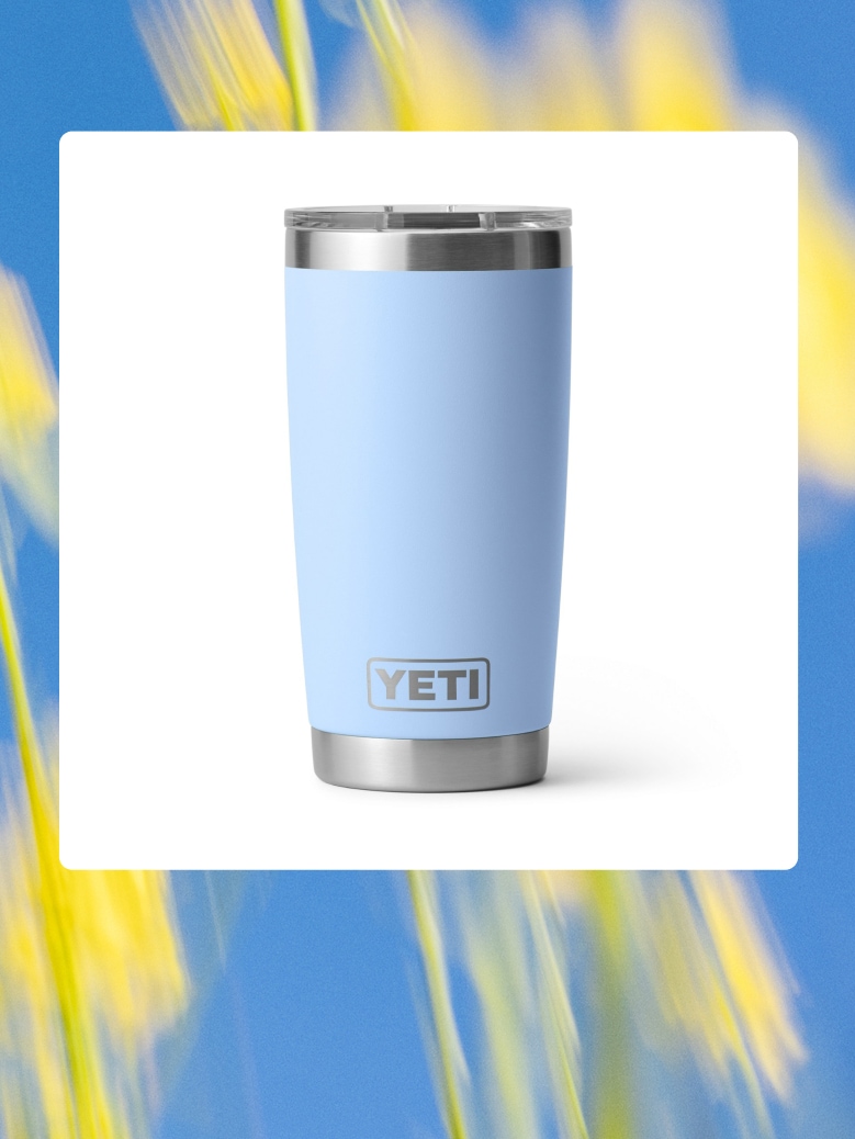 A blue YETI tumbler over an image of yellow flowers.