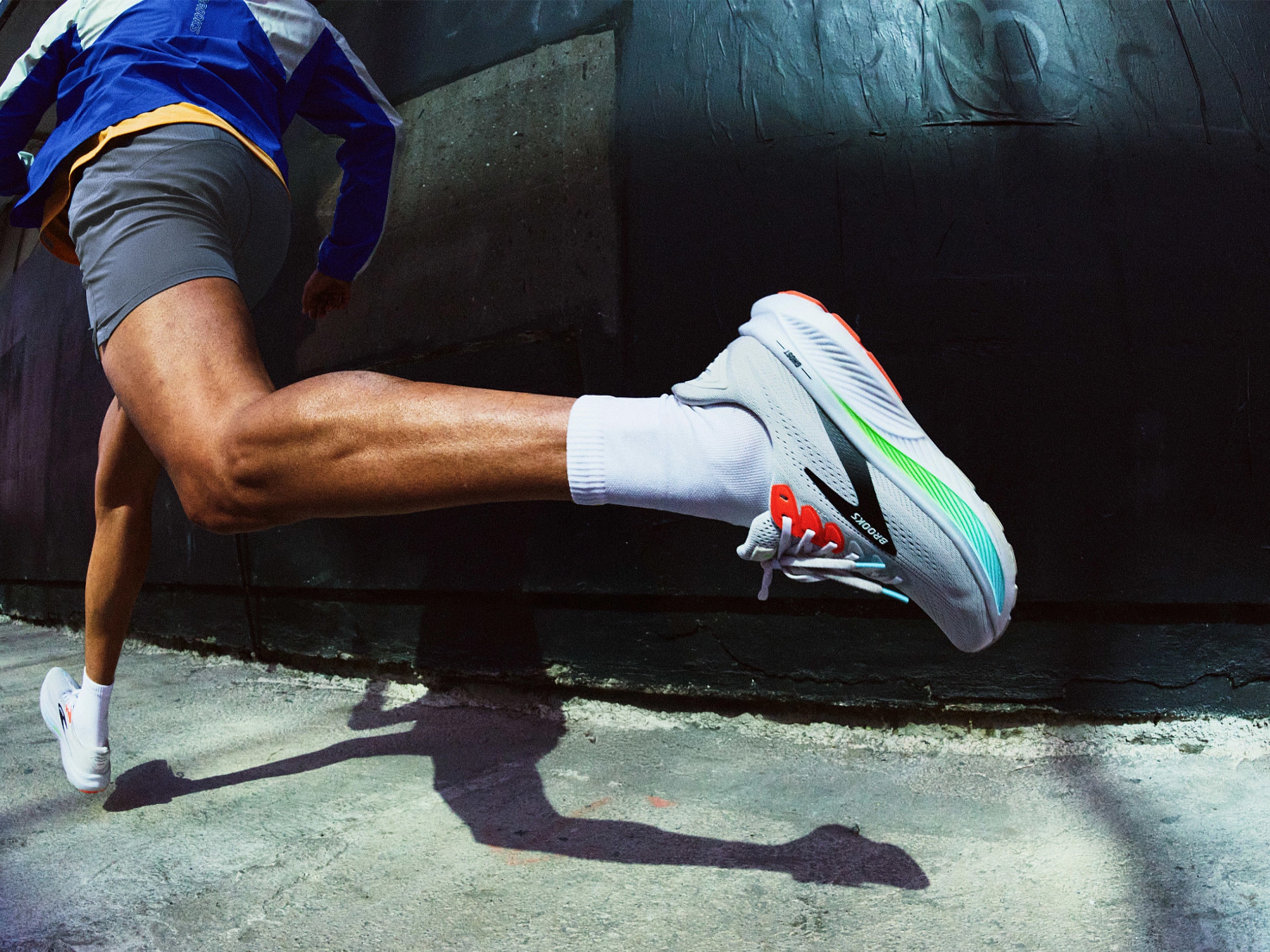 Person running on pavement in Brooks shoes