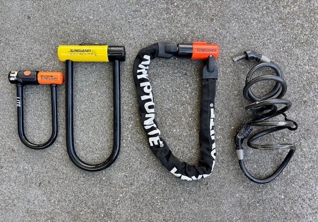 A photo of four bike locks including U-locks, chain lock and a cable lock