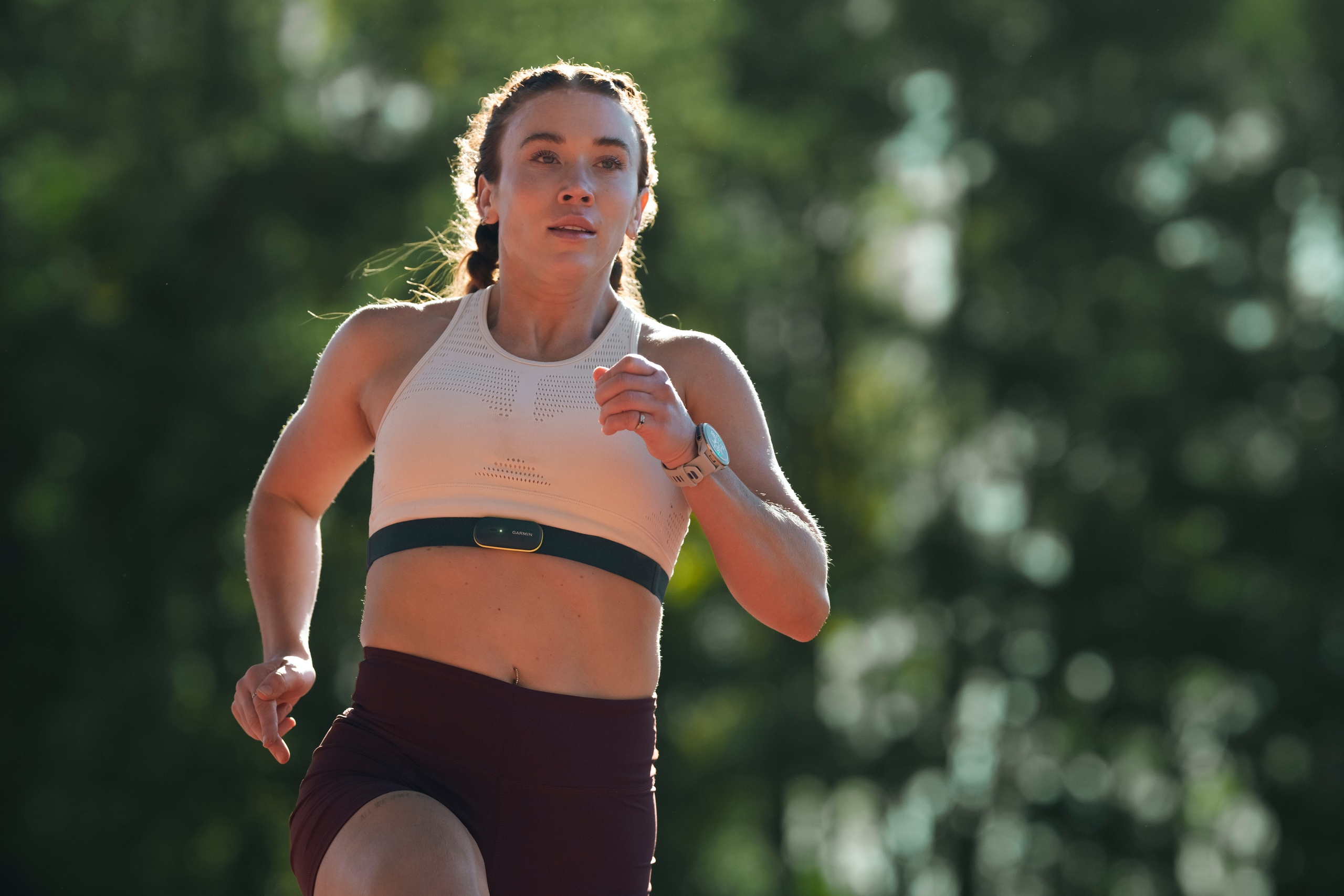 A person wearing a pink sports bra runs