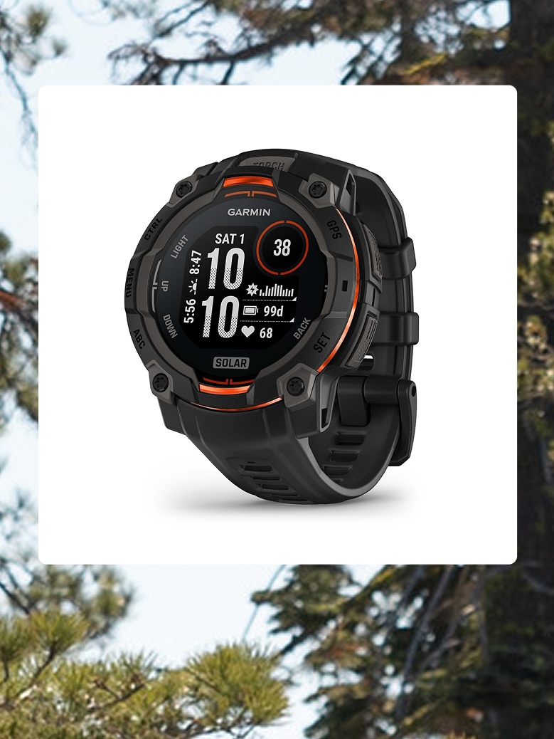 A Garmin GPS watch over an image of trees.