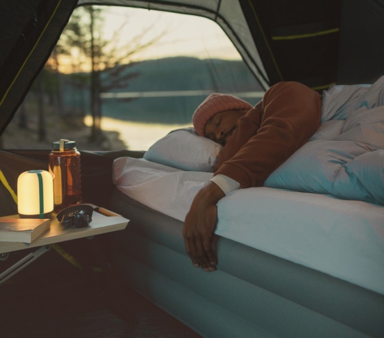 A person sleeps soundly on their Zempire Monstabed.