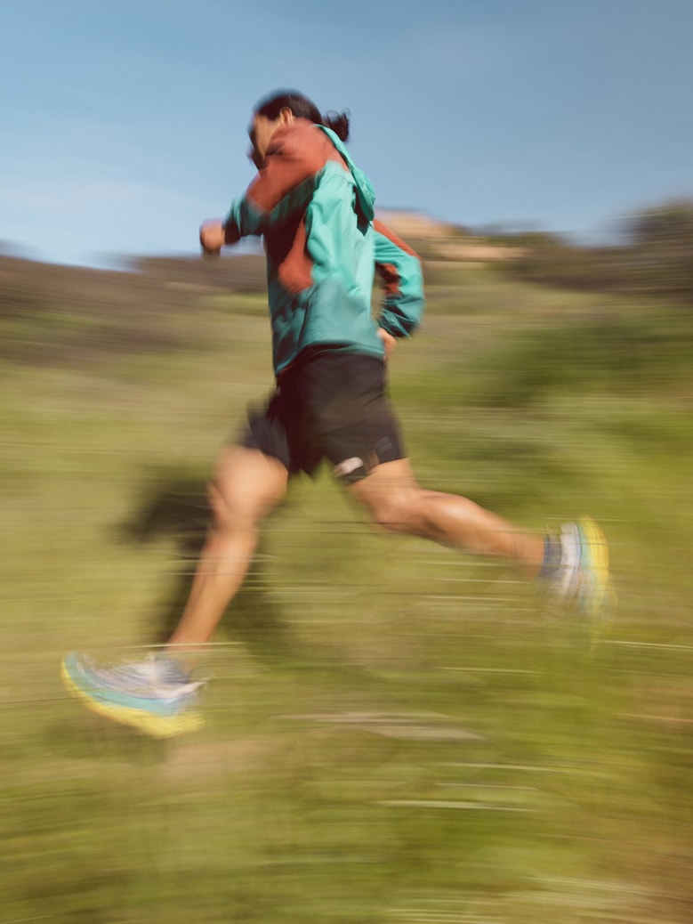 A person runs on a sunny day.