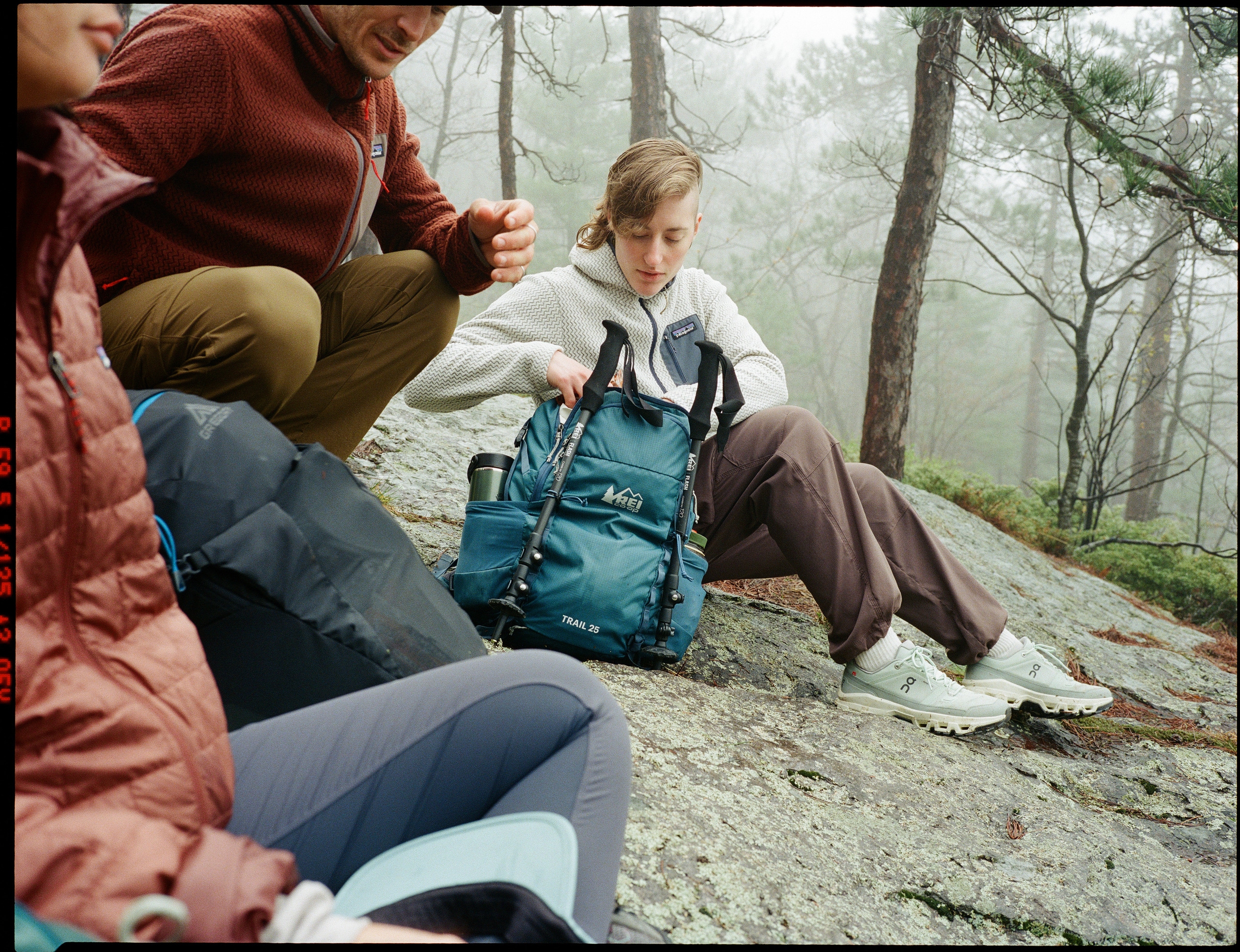 Three people take a break during a hike.