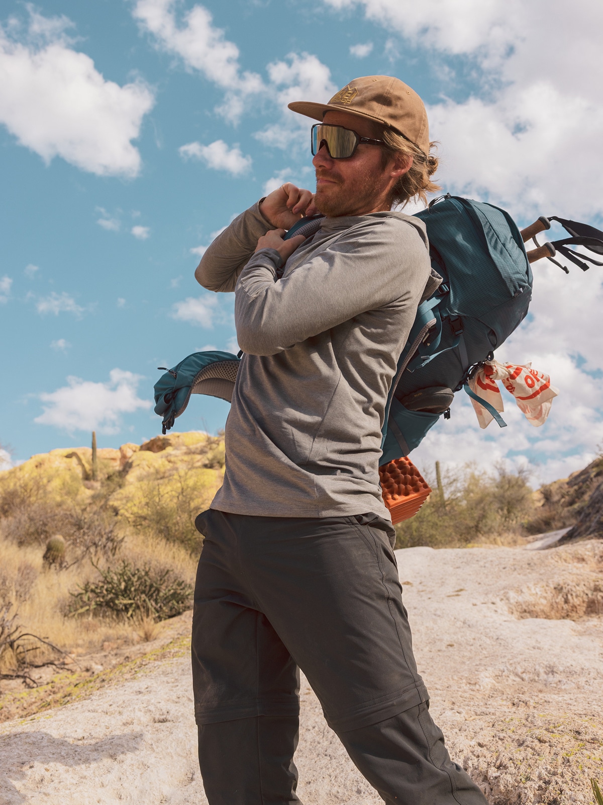 A person puts their backpack on.