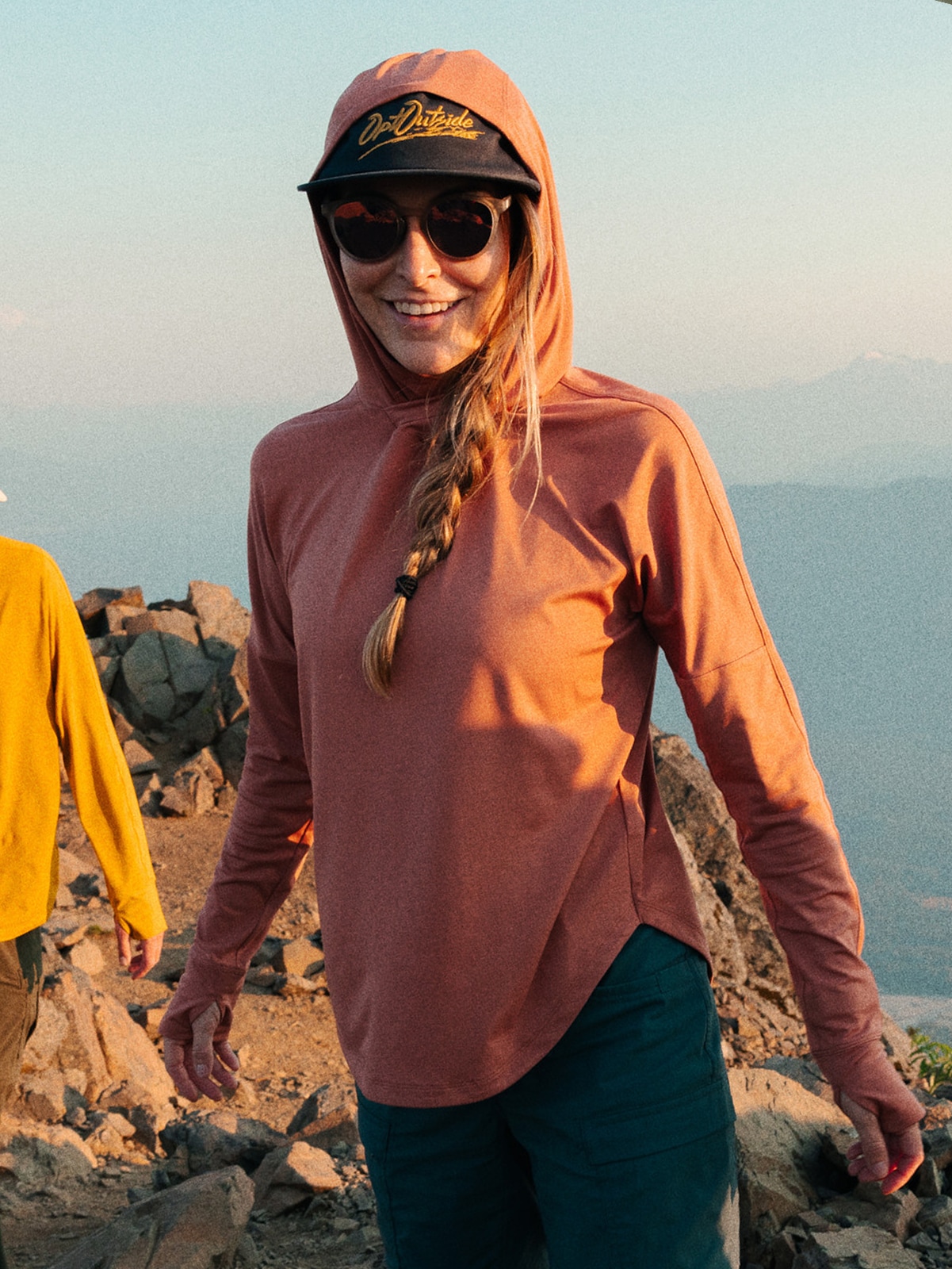 A person smiles for the camera while on a hike.