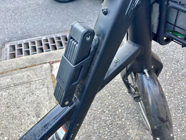 The Hiplok SWITCH Folding Lock is mounted on a bike frame