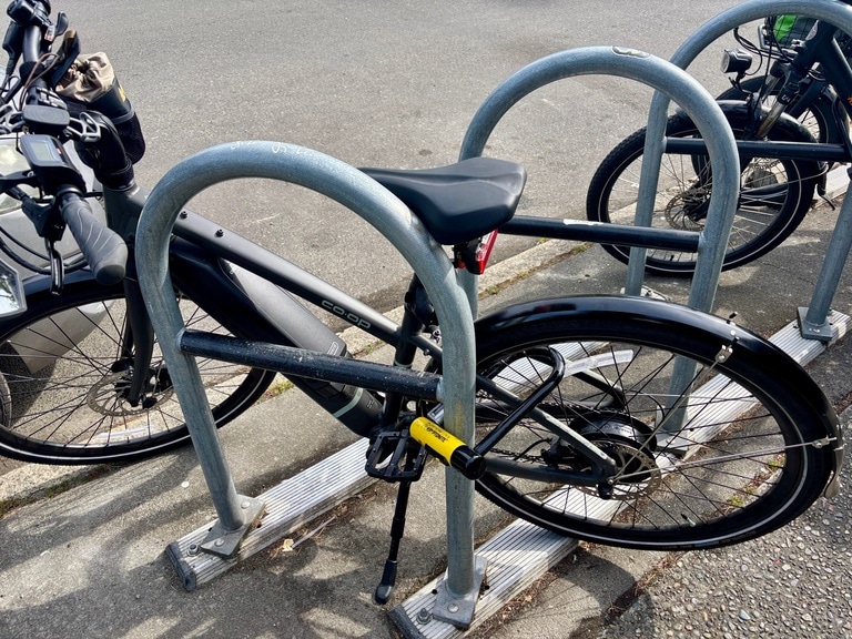 The Kryptonite New York U-Locks secures an e-bike to a fixed rack in Seattle. 