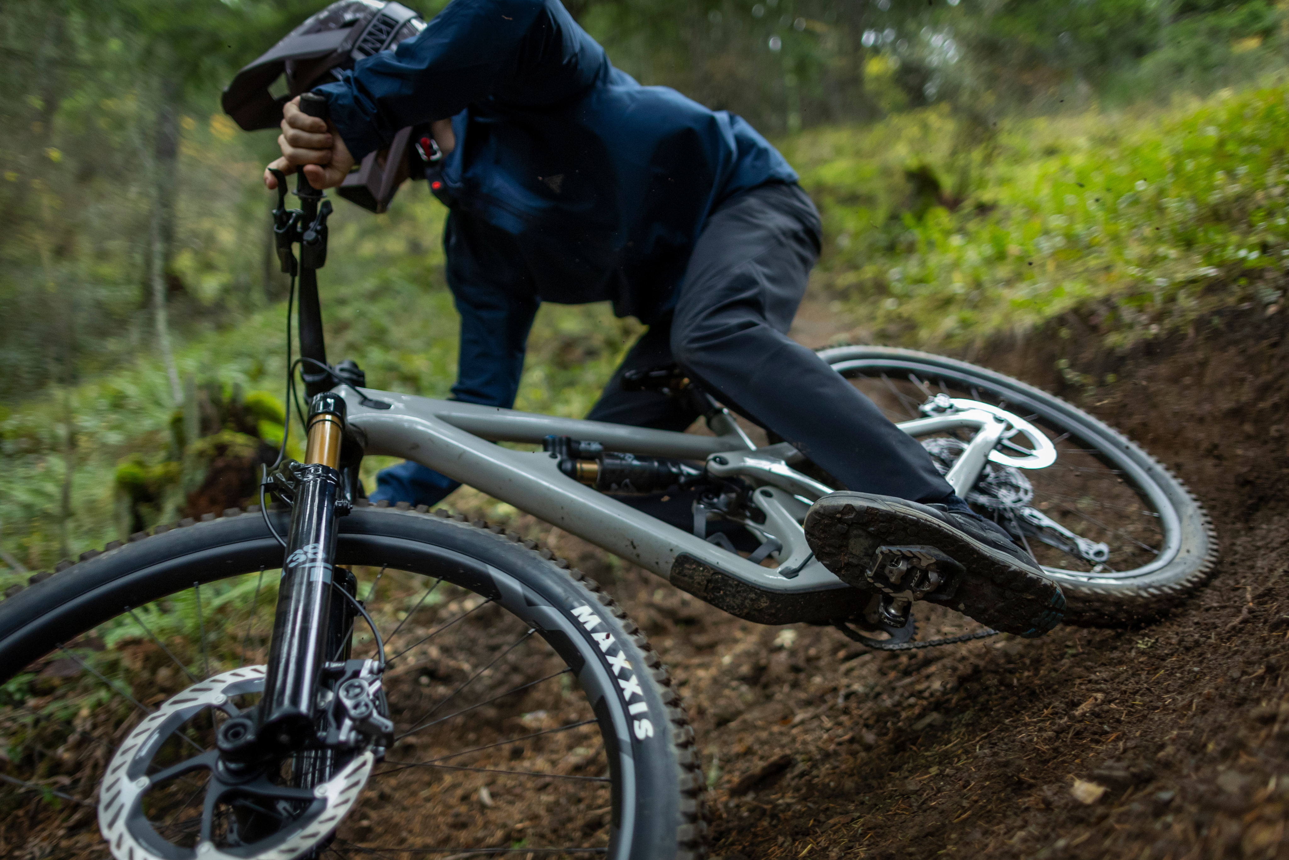 A person rides down a dirt trail on their bike.