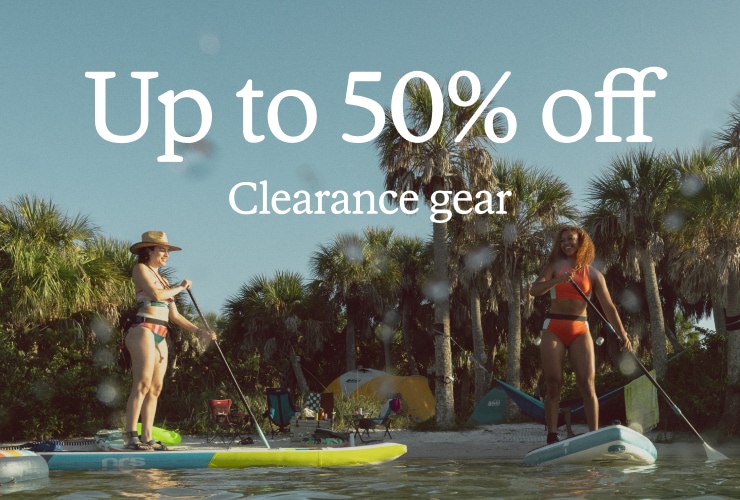 Two stand up paddle boarders on the water. Headline: Up to 50% off Clearance gear