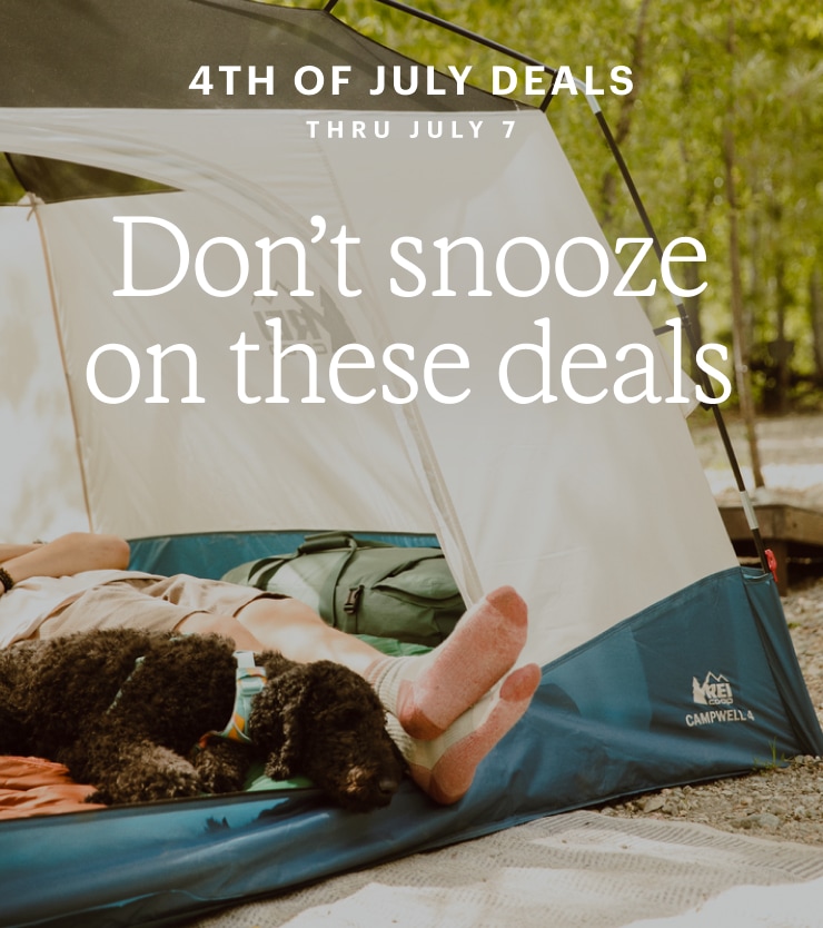 A dog and camper lounging inside a tent. Headline: Don't snooze on these deals. 4TH OF JULY DEALS THRU JULY 7
