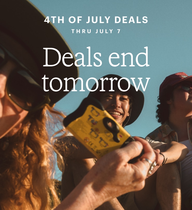 Dutch angle shot of friends outdoors, one of whom is brandishing a disposable camera. Headline: Deals end tomorrow. 4TH OF JULY DEALS THRU JULY 7