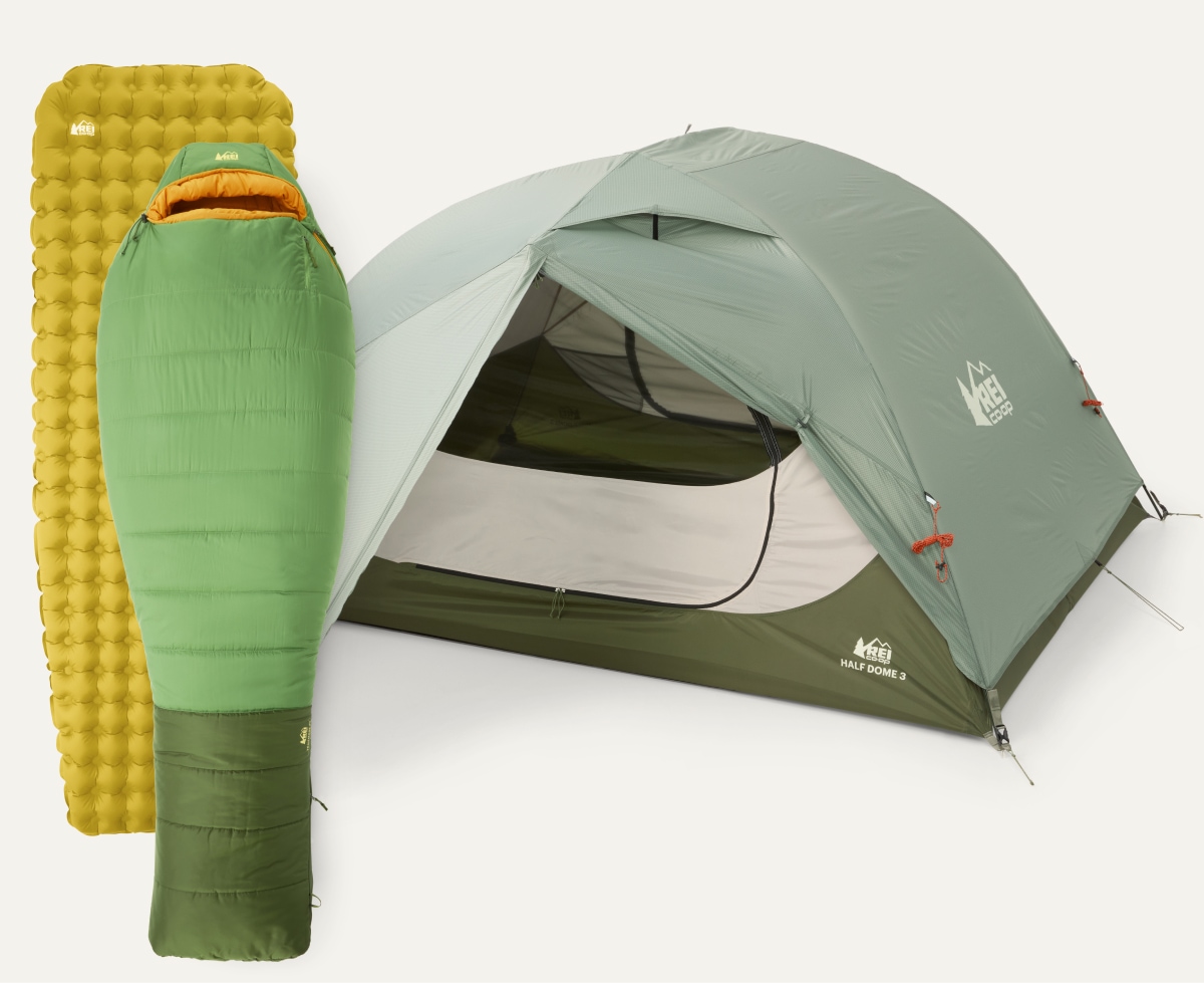 A tent, sleeping bag, and sleeping pad from the R E I Co-op brand.