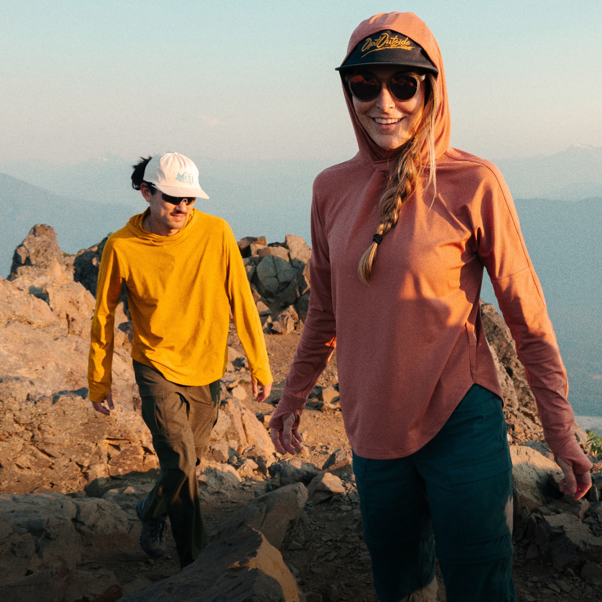 Two people walk along a rocky path.