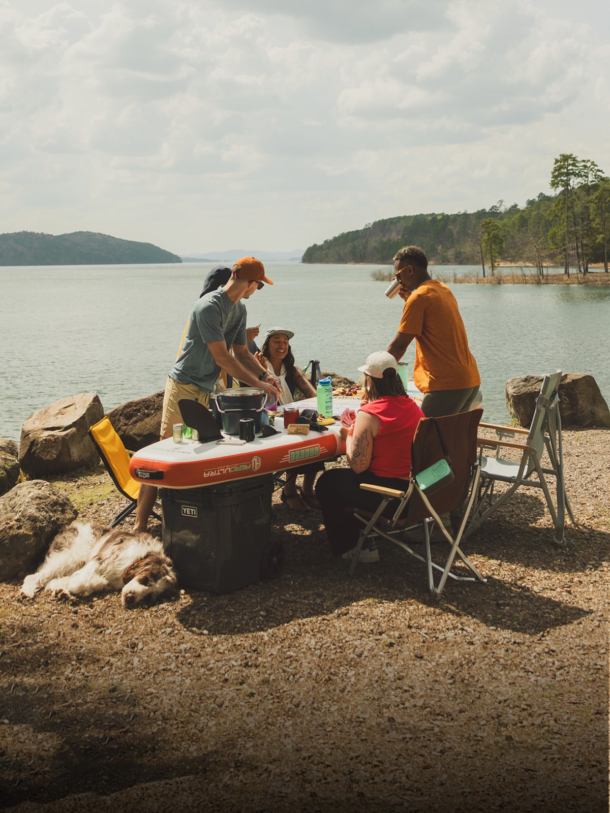 A group of people enjoy games & drinks at their campsite.