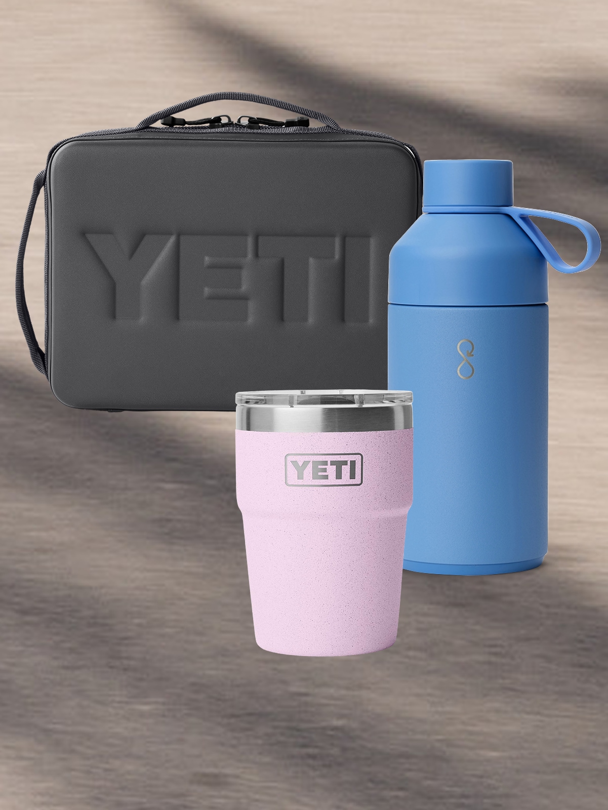 A YETI lunch box, stackable cup, & an Ocean Bottle insulated bottle.