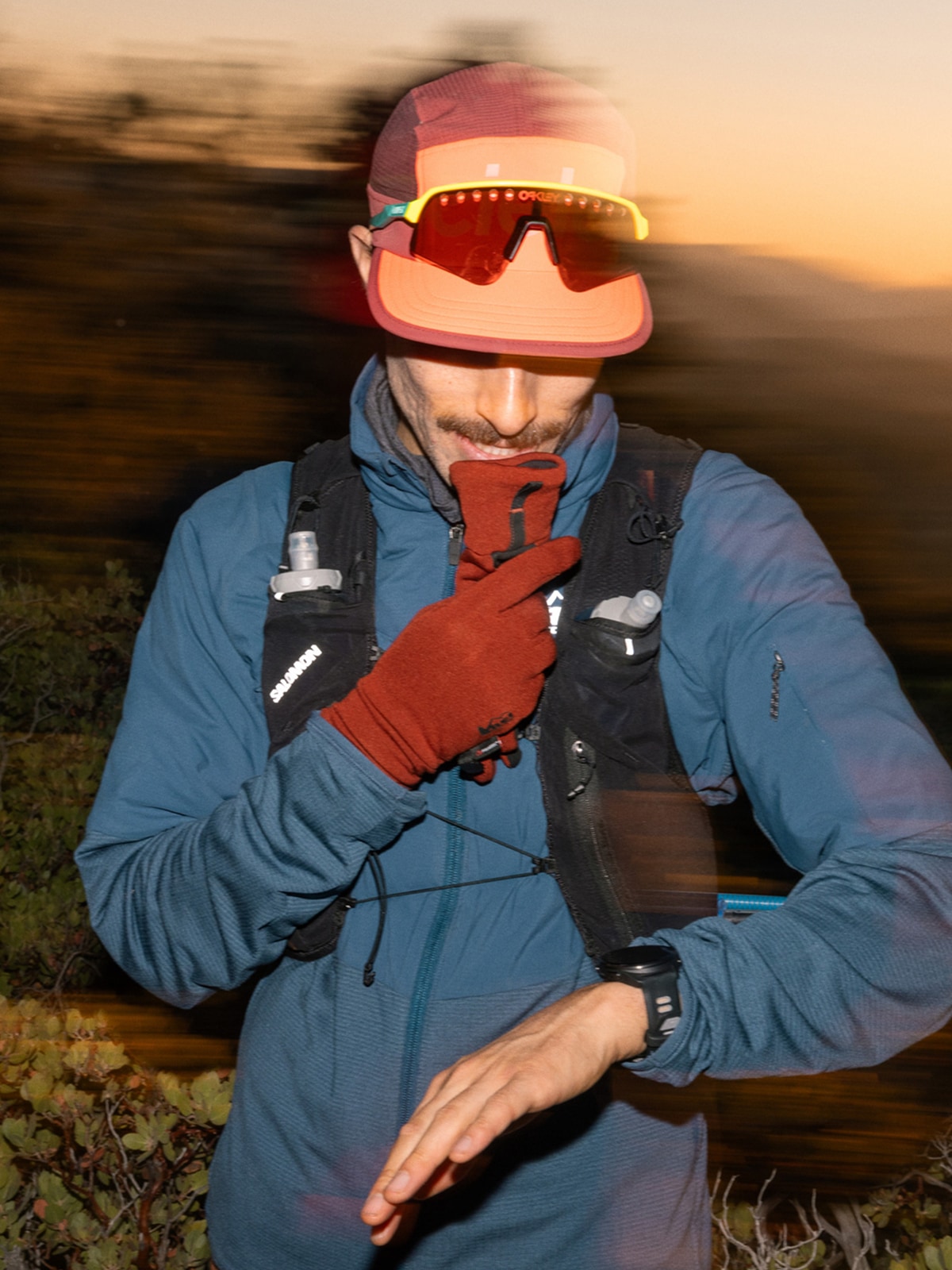 A person stops to check their watch while on a run.