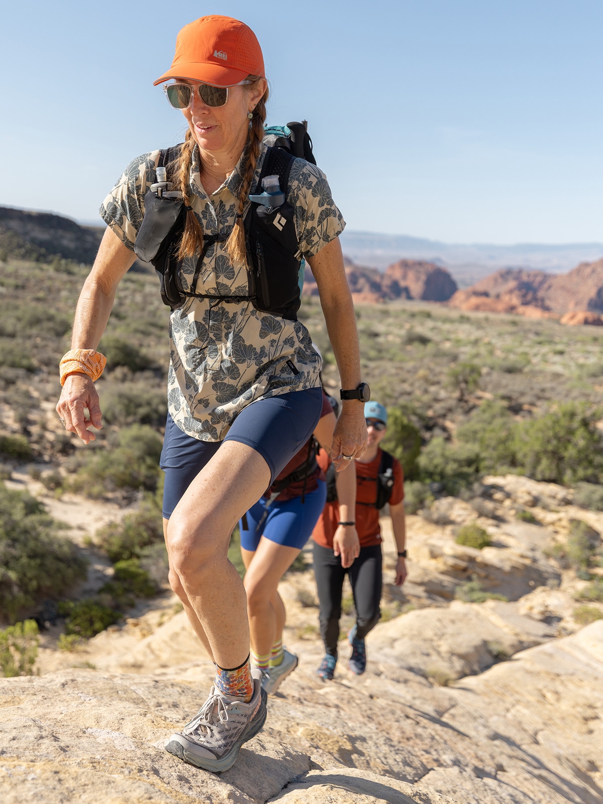 Two people hike up a rocky trail.