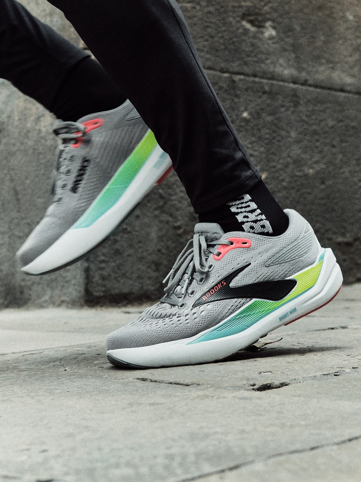 A person runs on a paved road in their Brooks shoes.